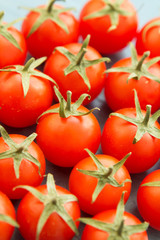 Small cherry tomatoes on a blue wooden