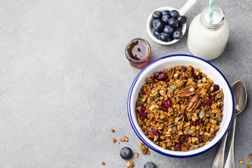 Healthy breakfast. Fresh granola, muesli with pumpkin, pecan nuts, maple syrup Copy space Top view