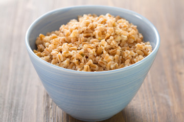 cereals in bowl on brown wooden background