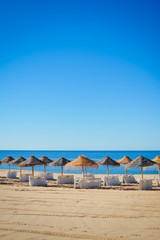 Beach ready for tourists. Golden sand with blue sky outdoors nature background