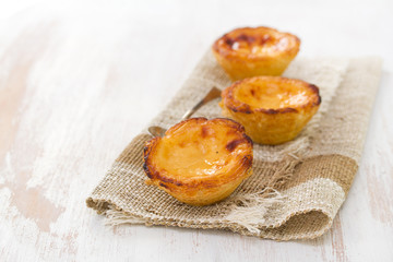 portuguese egg tart pastel de nata on white wooden background