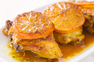 fried chicken with orange on white dish