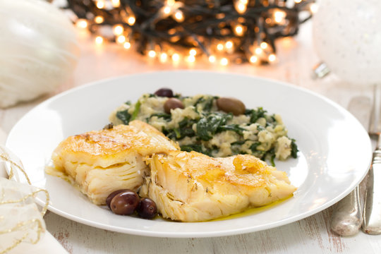 cod fish with vegetables on white plate