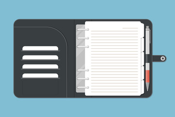 Opened notebook with pen in top view.