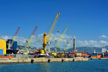 Fototapeta premium Cargo cranes with warehouse in Genova sea industrial port