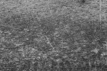 Grunge surface with grain and scratches in black and white with place for text.