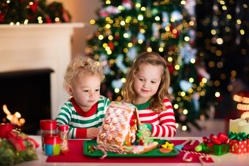 Kids making Christmas ginger bread house