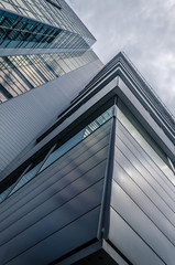 underside panoramic and perspective view to steel blue glass high rise building skyscrapers, industrial architecture