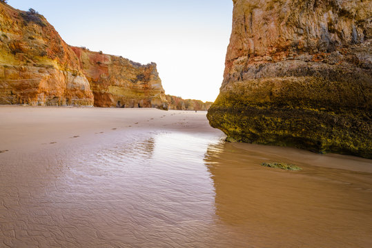 Early morning on the beach of Praia da Rocha, Portimao Coast. Algarve region. Portugal