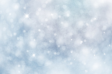 Artistic winter snowfall bokeh background with sparkle. Silver and soft blue colored blurry...