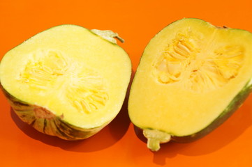 Yellow and ripe pumpkin lie on a bright background. 