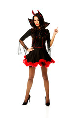 Woman wearing devil clothes pointing up 