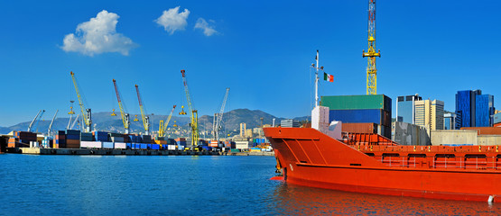 General cargo ship in the port waiting for containers in Genova, Italy .