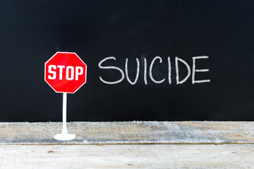 STOP SUICIDE message written on chalkboard