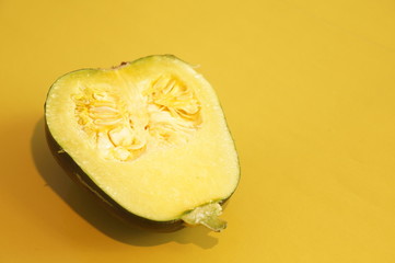 Yellow and ripe pumpkin lie on a bright background. 