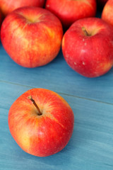 Fototapeta na wymiar Red apples on a blue table