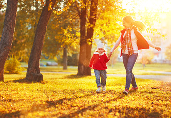 happy family mother and child little daughter on autumn walk