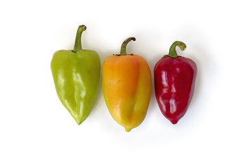 Red, yellow and green fresh bell papers. Vegetables isolated on white background with shadows. Clipping path.