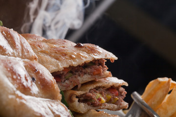 An Egyptian food  hawawshi is a  classic of spiced meat baked in  bread served with tahina