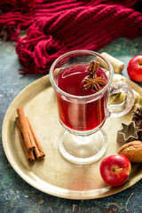 Mulled wine with apples, nuts and spices on copper tray. .