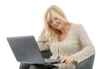 Portrait of a smiling mature woman using laptop