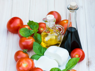 Raw product for Caprese Salad.Tomatoes,Basil,olive oil,balsamico.