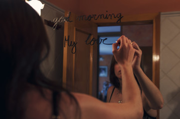Lipstick inscription good morning mirror and the reflection of a