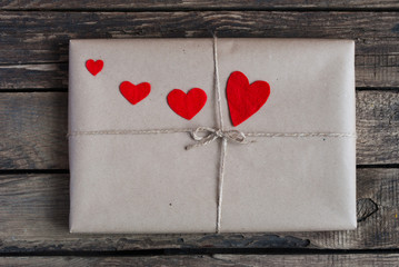 Gift wrapped in a kraft paper with red hearts