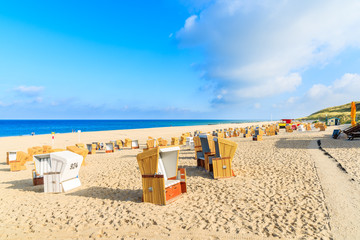 Chairs on sandy Wenningsted beach in morning light, Sylt island, Germany