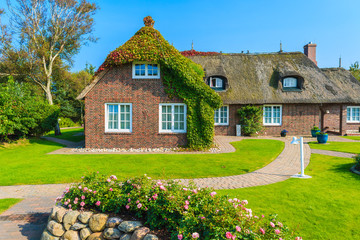 Typical Frisian house with straw roof in Kampen village on Sylt island, Germany