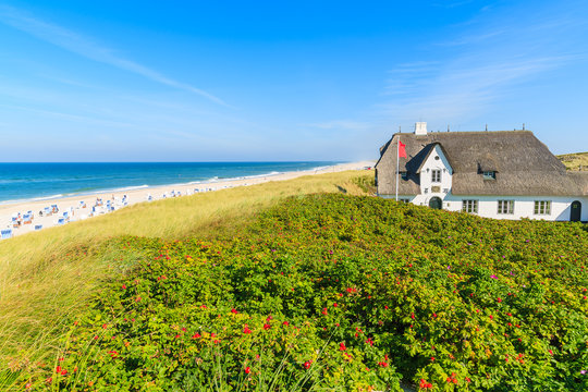 Typical Frisian house with straw roof on cliff at Kampen beach, Sylt island, Germany