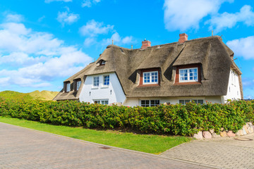 Traditional white house with thatched roof in Wenningsted village on Sylt island, Germany