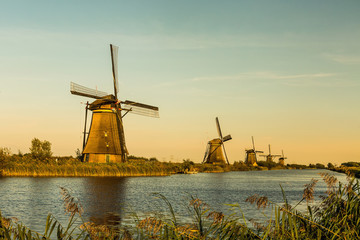 Fototapeta na wymiar Windmills of Kinderdijk near Rotterdam in Netherlands. Colorful spring scene in the famous Kinderdijk canals with windmills, UNESCO world heritage site