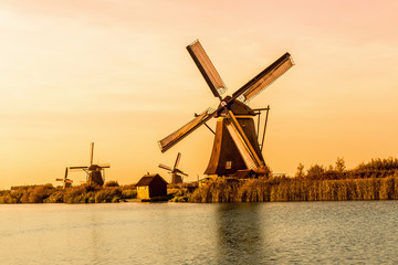 Windmills of Kinderdijk near Rotterdam in Netherlands. Colorful spring scene in the famous Kinderdijk canals with windmills, UNESCO world heritage site