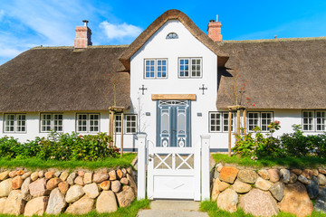 Traditional white house with thatched roof in Wenningsted village on Sylt island, Germany