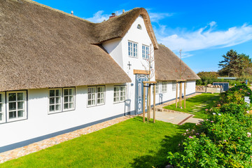Fototapeta na wymiar Traditional white house with thatched roof in Wenningsted village on Sylt island, Germany