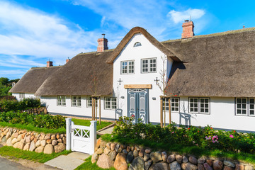 Traditional white house with thatched roof in Wenningsted village on Sylt island, Germany
