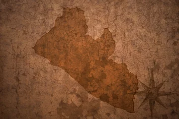 Wall murals Old dirty textured wall liberia map on a old vintage crack paper background