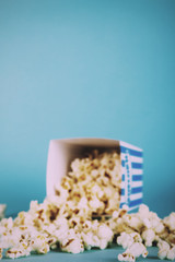 Popcorn bucket against a blue background Vintage Retro Filter.