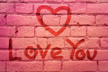 On the wall inscription hand - Love You and drawing a heart