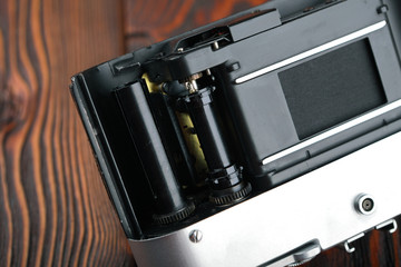 The old film camera on wooden table.