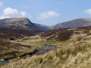 View of hills and moorland at the top of the Grey Mare's Tail waterfall, near Moffat, Southern Scotland on a sunny day in early Springtime 