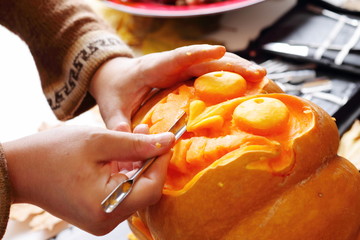 Carving out a pumpkin to prepare halloween lantern