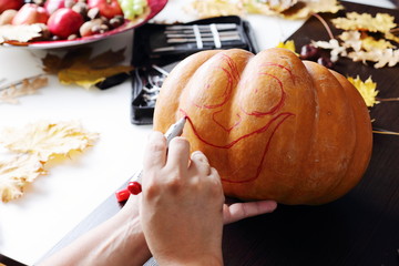 Carving out a pumpkin to prepare halloween lantern