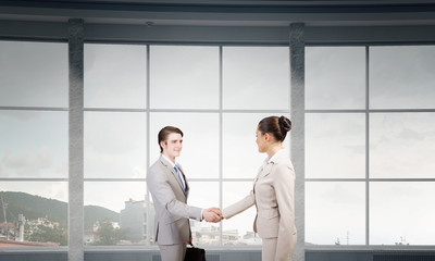 Fototapeta premium Business partners handshake . Mixed media