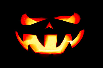 very scary Halloween pumpkin isolated on black background with i