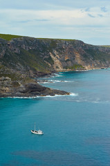 Small fishing vessel in a rocky coastal landscape cliff bay south australia