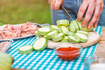 Man cutting zucchini on cutting board