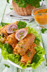 Meat rolls stuffed with bacon and pickled cucumber
