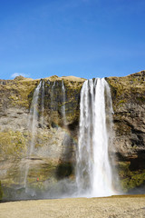 Beautiful  Seljalandsfoss waterfall with river and meadow